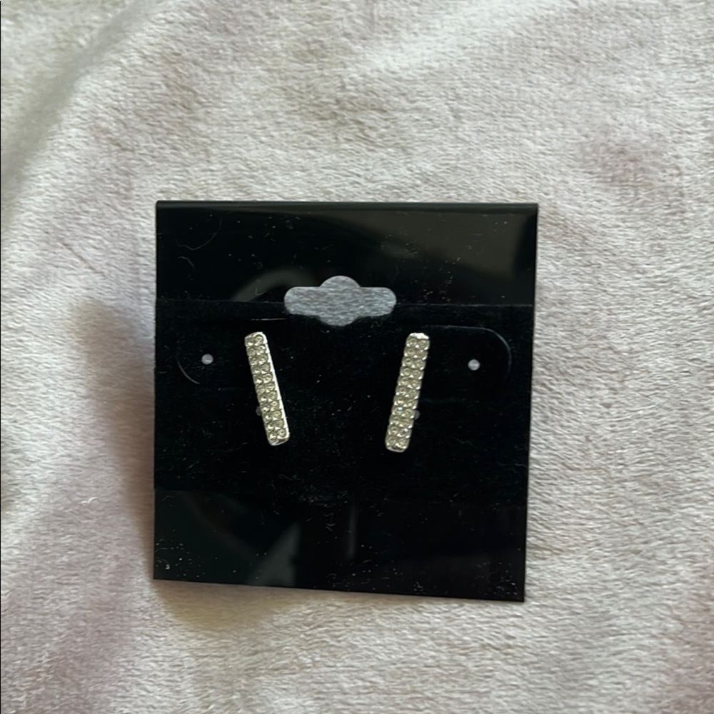 12 pairs of silver earrings.